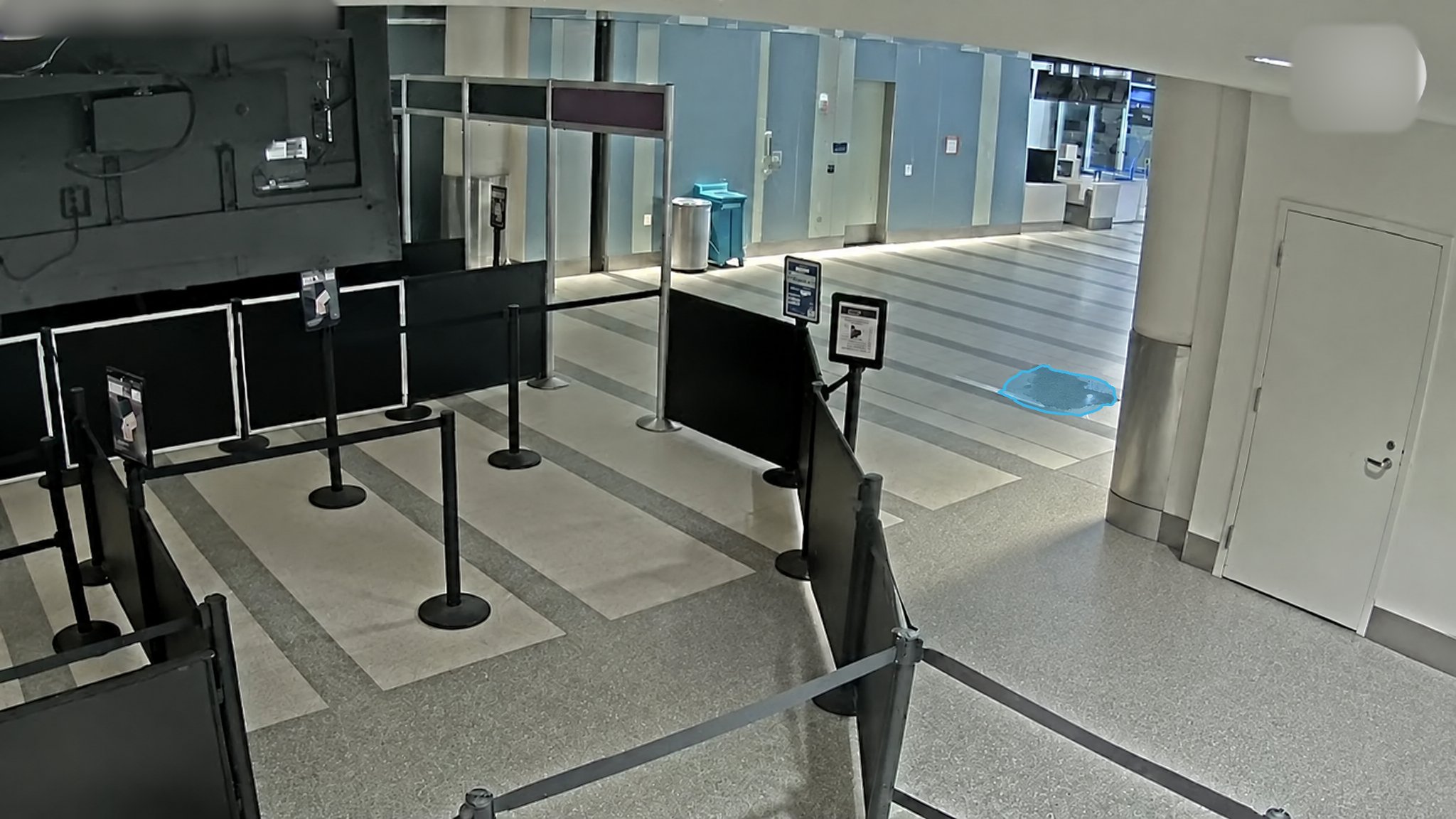 Airport Checkpoint Fluid Spill — puddle detection overlay
