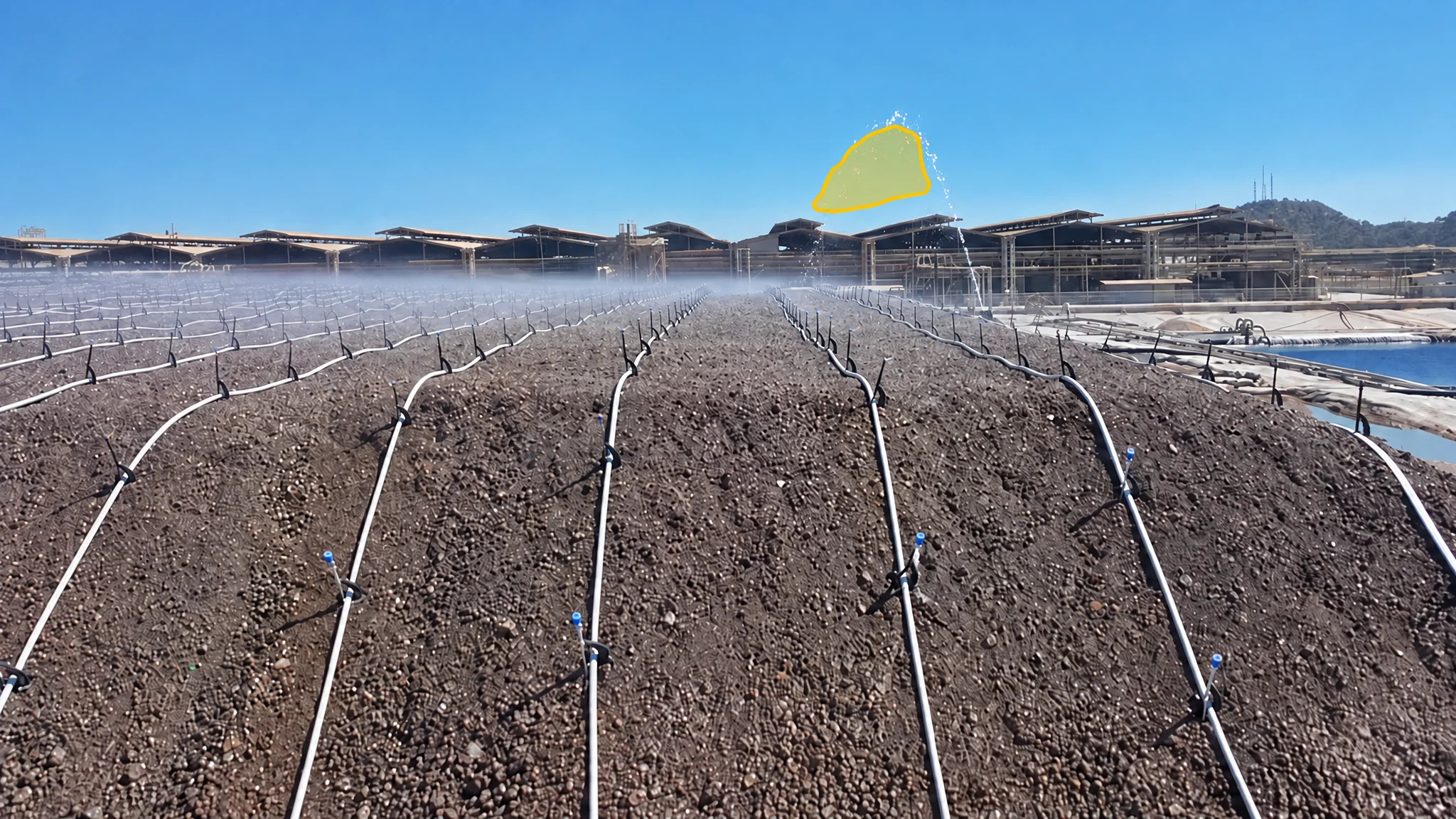 Leach pad irrigation lines with a yellow detection overlay marking the elevated spray from a malfunctioning spray line.